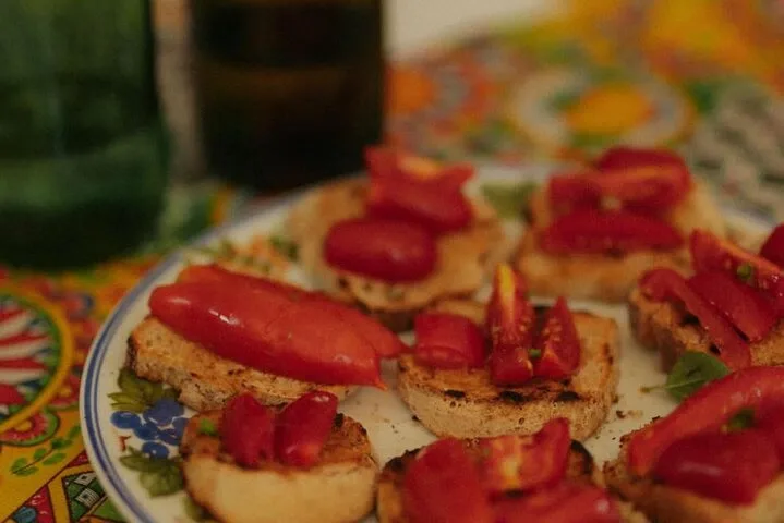 Bruschetta with red peppers and tomatoes on a painted plate